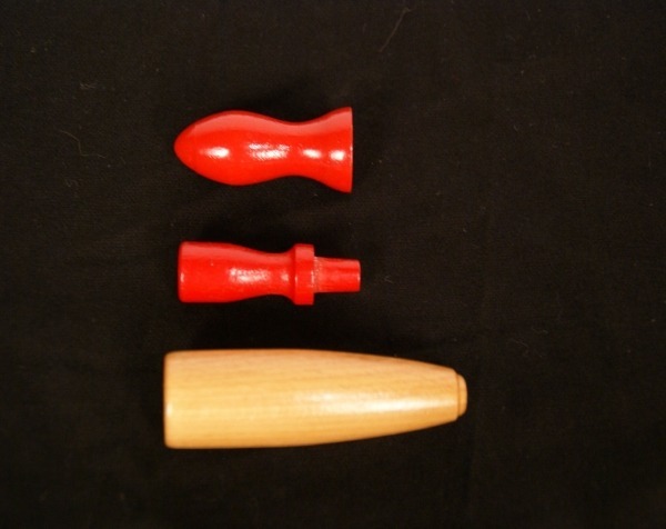 Three custom wooden rolling pin handles, two painted red and one with a clear finish.